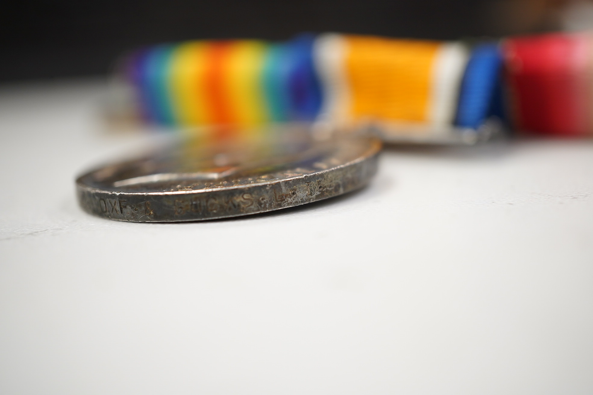 A First World War medal trio awarded to Pte. J. Ball Oxf. & Bucks. L.I., together with an oak mantle clock inset with a memorial plaque awarded to George John Ball, plus related paperwork. Condition - fair to good